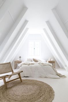 an attic bedroom with white walls and carpeted flooring is pictured in this image