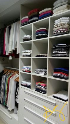 the closet is full of clothes and folded shirts