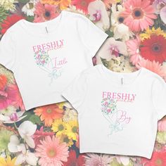 two t - shirts with the words freshly picked on them in front of colorful flowers