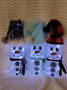 three snowman bags with lights on them