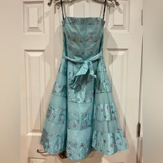 Betsey Johnson Evening Blue Floral Puffy Dress. Size: 6. Comes With Detachable Straps. Embroidered Rosettes. Multiple Layers Of Lining. Ribbon Is Removable. Side Zipper. Comes With Extra Buttons. Shell And Lining 100% Polyester. Other Linings Are Tulle And Satin. Dry Clean Only. Vintage Style. New With Tags And (Sadly) Never Worn (Only Tried On In My House In The Photos). In Great Condition. Blue Strapless Dress For Garden Party, Strapless Blue Dress For Garden Party, Blue Silk Dress For Garden Party, Silk Blue Dress For Garden Party, Blue Lined Wedding Dress, Blue Silk Lined Dress, Vintage Betsey Johnson Dress, Blue And Purple Dress, Vintage Dress Outfit