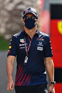 a man wearing a face mask walking down the street