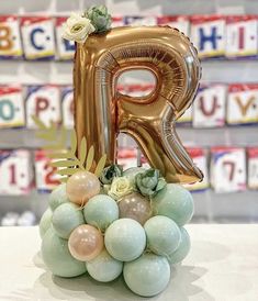 the letter p is surrounded by balloons and succulents