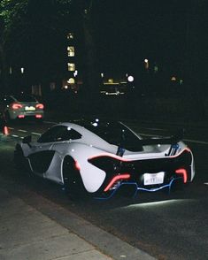 a futuristic car is parked on the side of the road