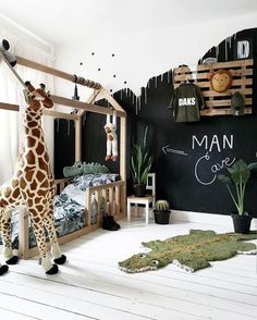 a giraffe standing next to a bed in a room