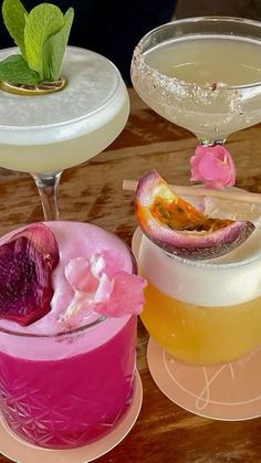 three different types of cocktails sitting on top of plates