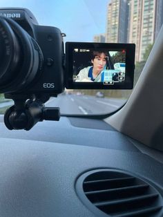 a camera is attached to the dashboard of a car