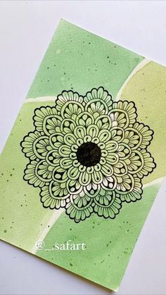 a green and white card with a flower on it