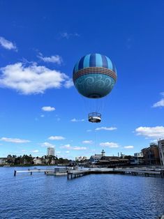 a hot air balloon is flying over the water