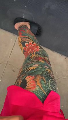 a woman's leg with tattoos on it