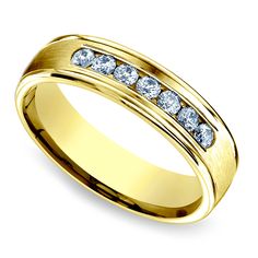 a yellow gold wedding ring with channeled diamonds