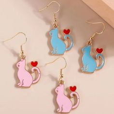 This Unique Pair Is A Wonderful Addition To Your Wardrobe And Your Style; Sure To Get Lots Of Compliments! Available In Pink Or Blue While Supplies Last! Gsumpa50600jnd6 Cute Cat Design Earrings For Party, Cute Blue Jewelry With Heart Charm, Cute Blue Earrings For Valentine's Day, Cute Blue Jewelry For Valentine's Day, Cute Blue Heart Jewelry, Cute Blue Heart-shaped Jewelry, Cute Blue Heart Earrings, Playful Blue Heart-shaped Jewelry, Kawaii Pink Cat Design Jewelry