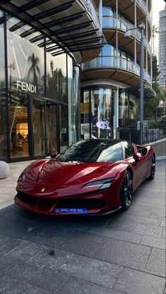 a red sports car parked in front of a building