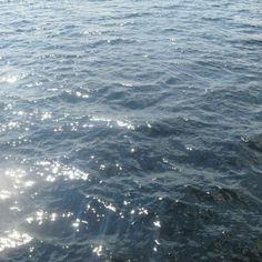 the sun shines brightly on the water as it reflects off the surface of the ocean