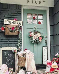 a front door decorated for valentine's day with wreaths and other items on display