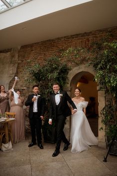 the bride and groom are standing in front of their guests