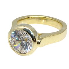 a yellow gold ring with a round cut diamond