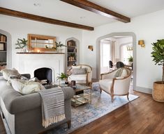 a living room filled with furniture and a fire place in the middle of a room