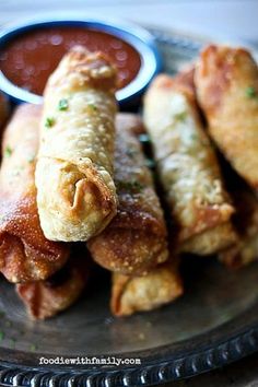 some food is sitting on a plate with dipping sauce