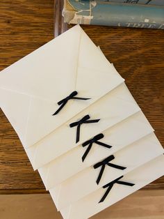 an envelope with japanese writing on it sitting next to a stack of books and magazines