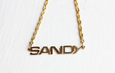 This is an awesome vintage name necklace from about the 70s! It is 14K Gold Plated and has never been worn.The name is about 1.5" wide.Model shown wearing “Marie” name necklace.NOTE: This CAN NOT be custom made. They are vintage, thus you will receive the exact same name in the photo above. We have lots of vintage name jewelry in the shop! You can see them all here at this link:https://www.etsy.com/shop/diamentdesigns/search?search_query=name&order=date_desc&view_type=gallery&ref=sho Vintage Personalized Nameplate Necklace, Personalized Vintage Nameplate Necklace, Vintage Nameplate Necklaces, Vintage Custom Name Jewelry Nameplate, Vintage Custom Name Nameplate Jewelry, Vintage Custom Nameplate Jewelry, Vintage Gold Name Necklace, Vintage Nameplate Necklace For Anniversary, Vintage Nameplate Necklace As Gift