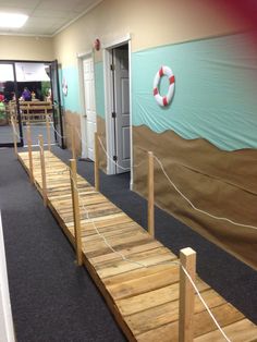 a long wooden walkway in an office building