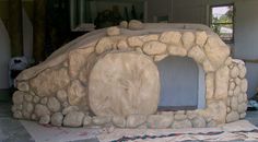 a stone oven sitting in the middle of a room