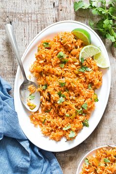 mexican rice with lime and cilantro served on a white plate