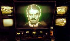 an old television with a man's face on it in front of several tvs