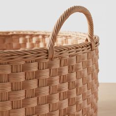 a woven basket sitting on top of a wooden table