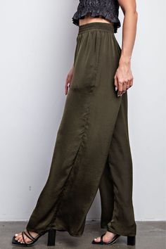 Give your wardrobe a stylish upgrade with these Olive Waist Elastic Wide Leg Satin Pants. Made of smooth satin fabric with an elasticized waistband, these pants provide a flattering fit while allowing for maximum comfort. The wide leg cut adds sophistication to your look. Fabric & fit: Model is wearing size Small. Solid Satin Pants With Elastic Waistband, Casual Stretch Satin Bottoms, Casual High-waisted Satin Pants, Casual Satin Stretch Bottoms, Stretch Satin Casual Bottoms, Casual Satin Trousers, Wide Leg Rayon Pull-on Pants, Wide-leg Pull-on Rayon Pants, Wide-leg Rayon Pull-on Pants