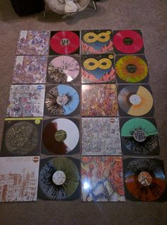 many different colored records are arranged on the floor