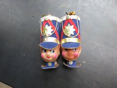 two toy soldier's shoes on a black surface