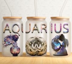 three jars with the word aquarius painted on them