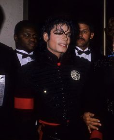 michael jackson is surrounded by other men in tuxedos