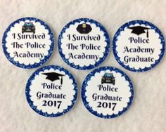 four badges with the words police graduate in blue and white on them, sitting next to each other