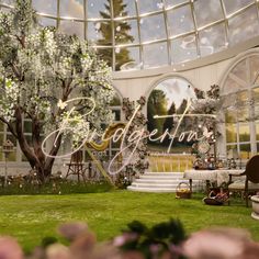 an image of a garden setting with flowers and trees in the background that says welcome