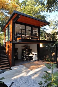 a modern house with an open floor plan and stairs leading up to the upper level