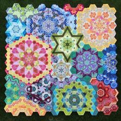 a patchwork quilt with many different designs on it