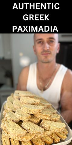 a man holding a platter full of corn on the cob with text overlay reading authentic greek paximadia