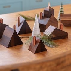 small wooden christmas trees sitting on top of a table