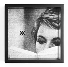 a black and white photo of a woman reading a book with the words x on it