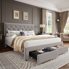 a bedroom with a large bed and an ottoman on the bottom shelf next to it