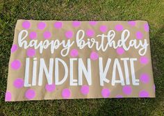 a birthday sign that says happy birthday linden kate on it in pink and white polka dots