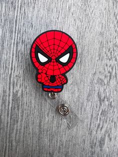 Spider superhero character badge design made of soft plastic.  Attached to alligator style retractable badge reel. We can place on slide belt style clip if you like. Please add note or send message.  We have more spider-man badges please see other listings.  TERMS AND CONDITIONS By purchasing this item, you acknowledge that you have read the listing description in full and that you agree to my shop policies. We also have a section for FAQs. If you have any other questions or concerns about the i Hero Character, Holiday Angel, Custom Badges, Retractable Badge Reel