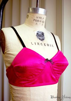 a mannequin wearing a pink and black top