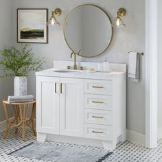 a bathroom with a sink, mirror and rug on the floor in front of it