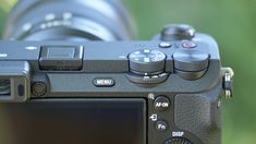 a close up view of a camera with focus on the lens and its flash dial