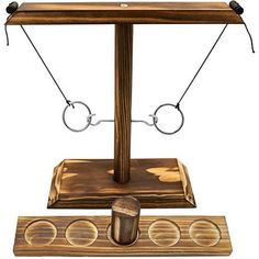 an old fashioned wooden balance scale with eye glasses on it's top and two metal bars attached to the sides