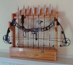 an old fashioned bow and arrow display on a mantel